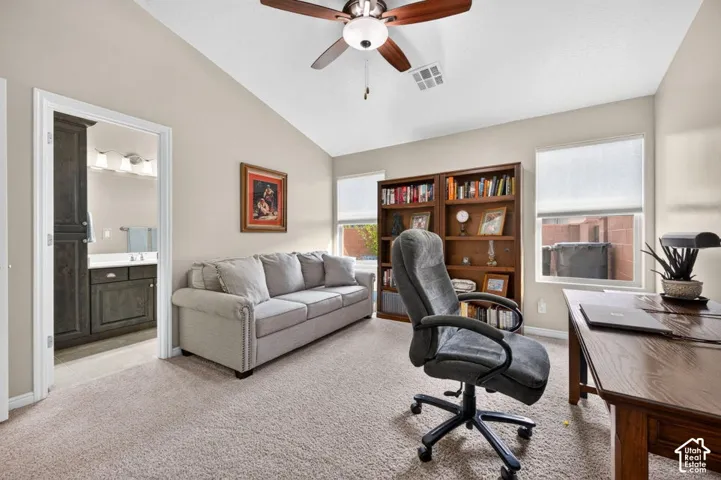 Vaulted ceilings, carpeting, and a ceiling fan with integrated lighting