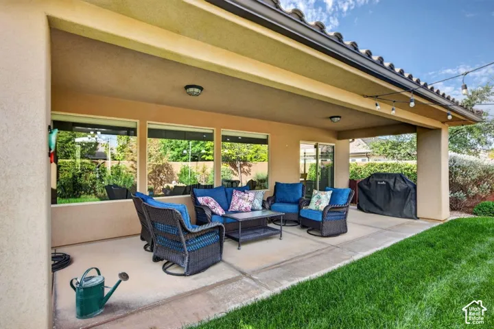Covered patio featuring concrete flooring, a tile roof, built-in ceiling lighting, and expansive window wall exposure