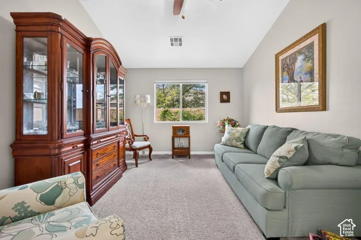 Vaulted ceiling, neutral wall tones, wall-to-wall carpeting, and a dual-pane window