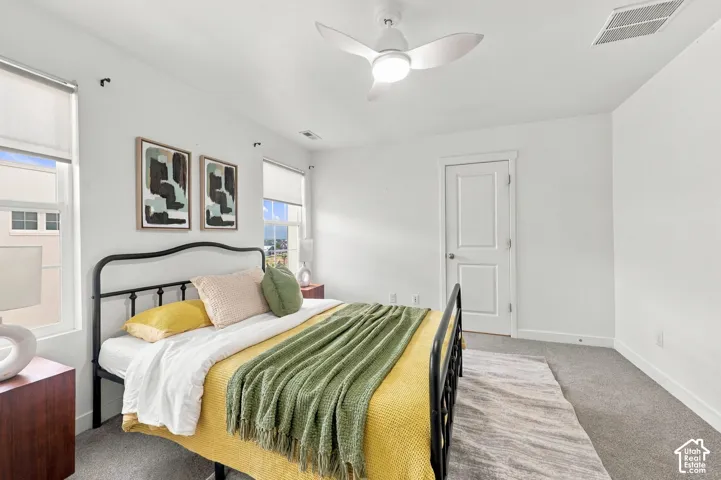 Recessed lighting, ceiling fan with integrated light, carpeted flooring, and window treatments
