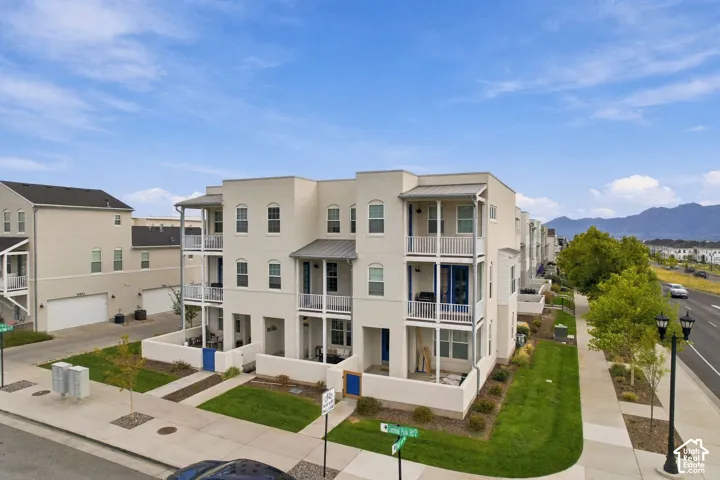 Multi-level residential units featuring balconies, ground-level patios, and stucco exteriors