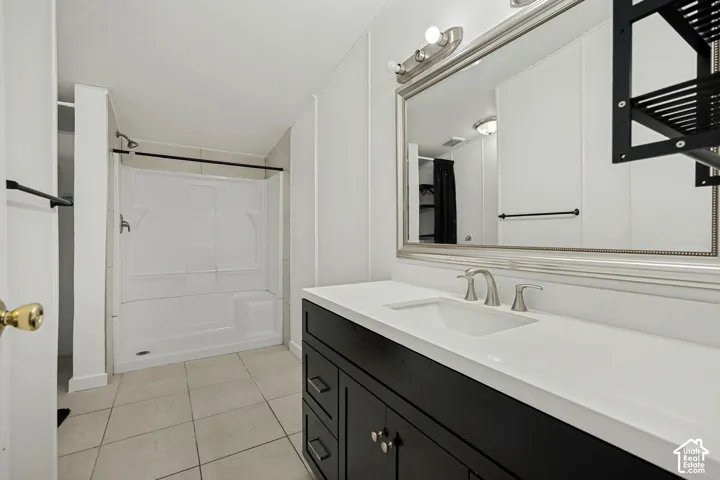 White bath and shower combination with a black shower rod