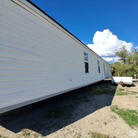 White horizontal siding exterior with metal roofing and inset windows