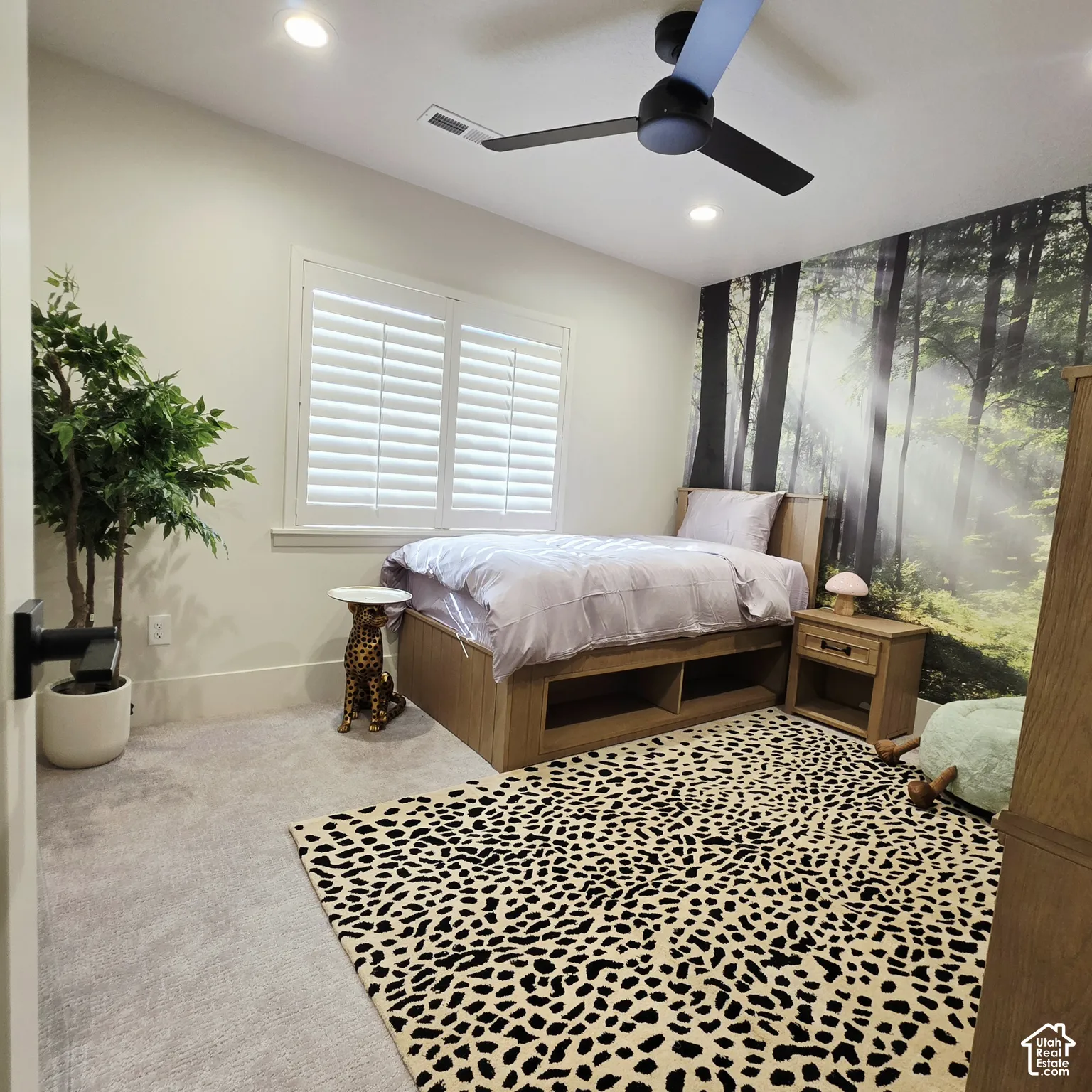 Interior room featuring white plantation shutters, recessed ceiling lighting, and a modern matte black ceiling fan