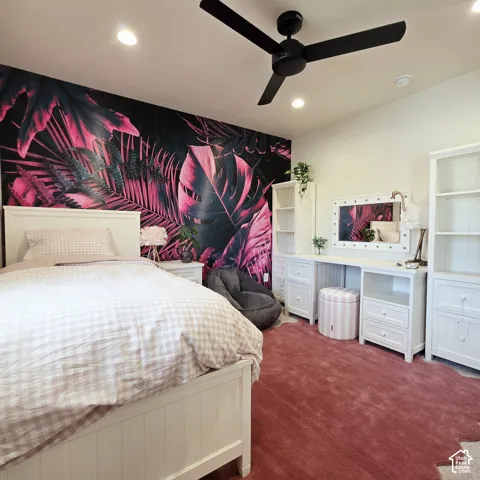 Accent wall with bold botanical wallpaper, recessed lighting, and matte black three-blade ceiling fan