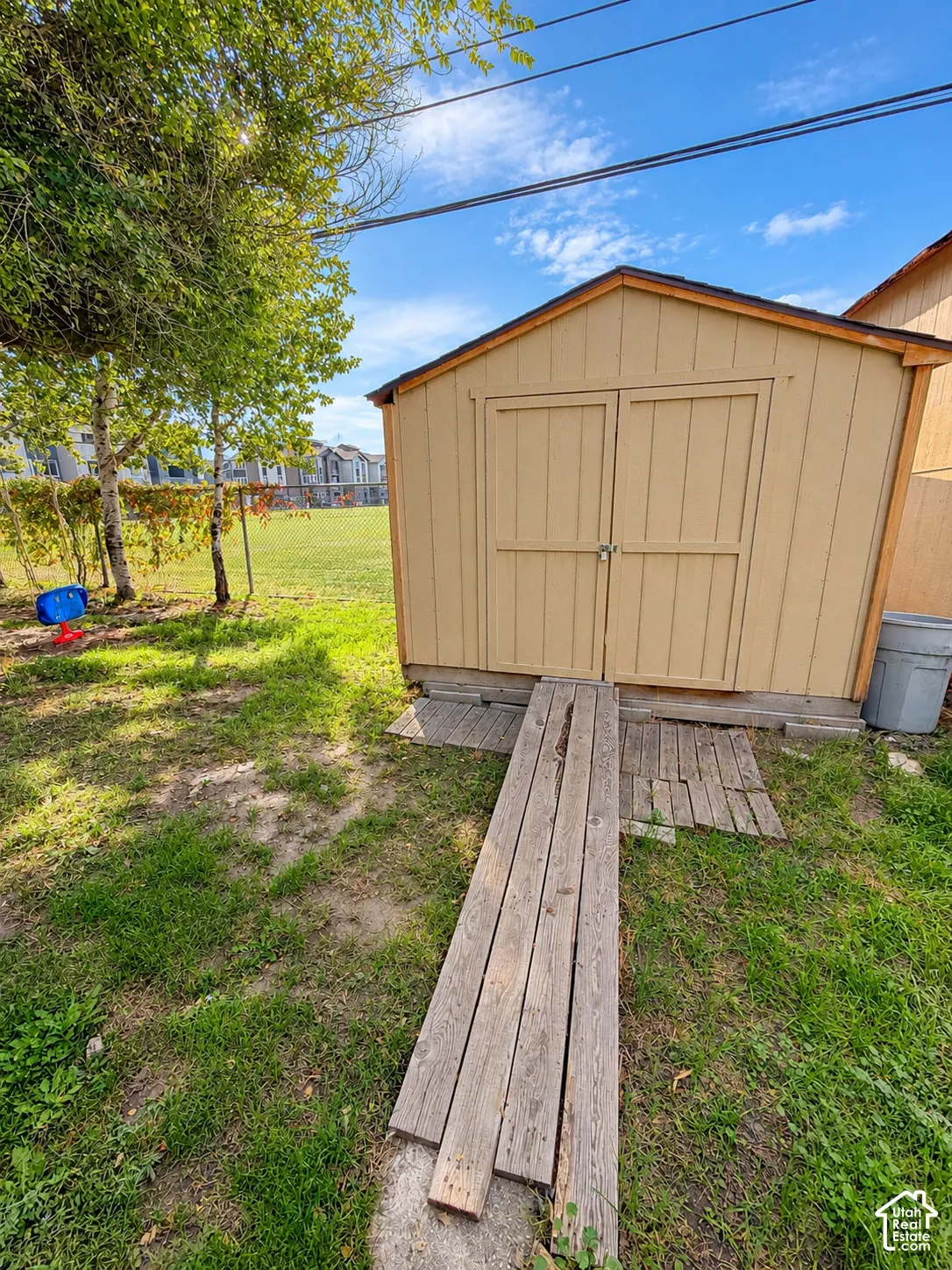 Detached storage shed with gabled roof and double doors