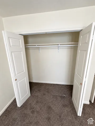 Built-in closet with dual paneled doors, wire shelving, and hanging rod