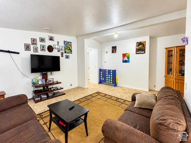 Neutral-toned interior featuring vinyl flooring and a built-in wood-finished corner cabinetry unit