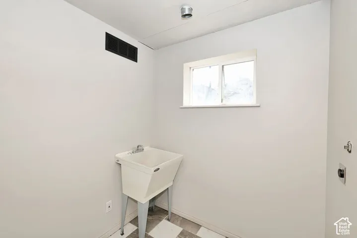 Utility sink, window, and checkered floor