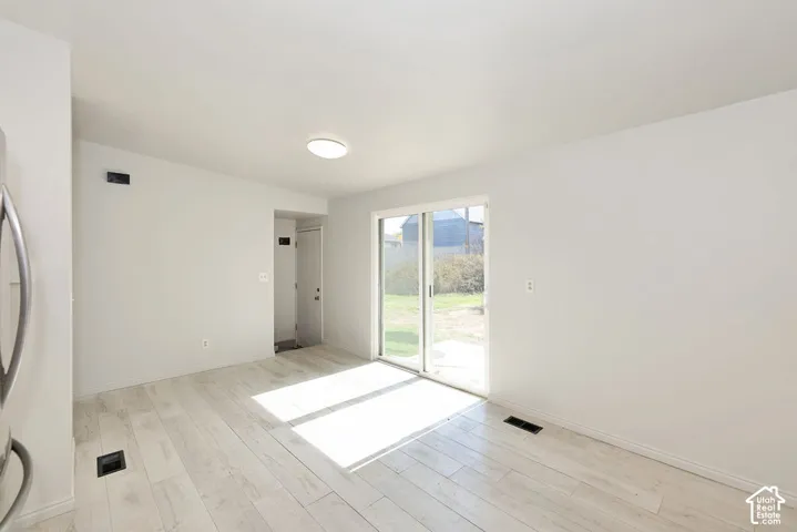 Light wood-finish flooring with a flush-mounted ceiling light fixture
