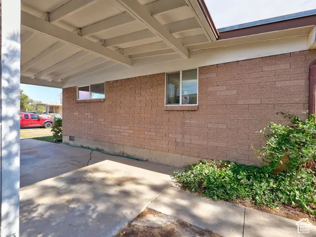 Attached carport with exposed rafter ceiling