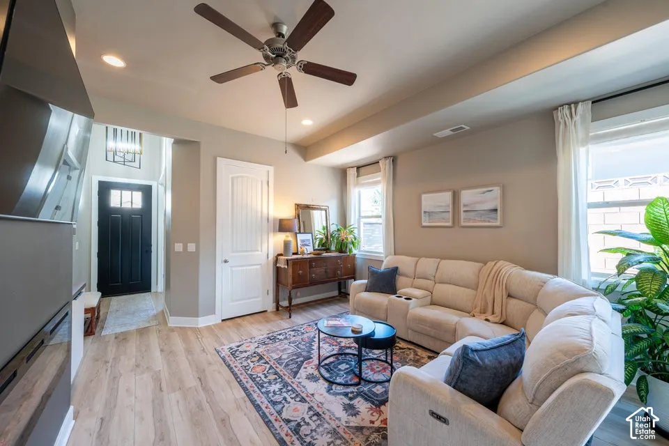 Wood-finish flooring, recessed lighting, ceiling fan, coffered ceiling, and paneled interior door
