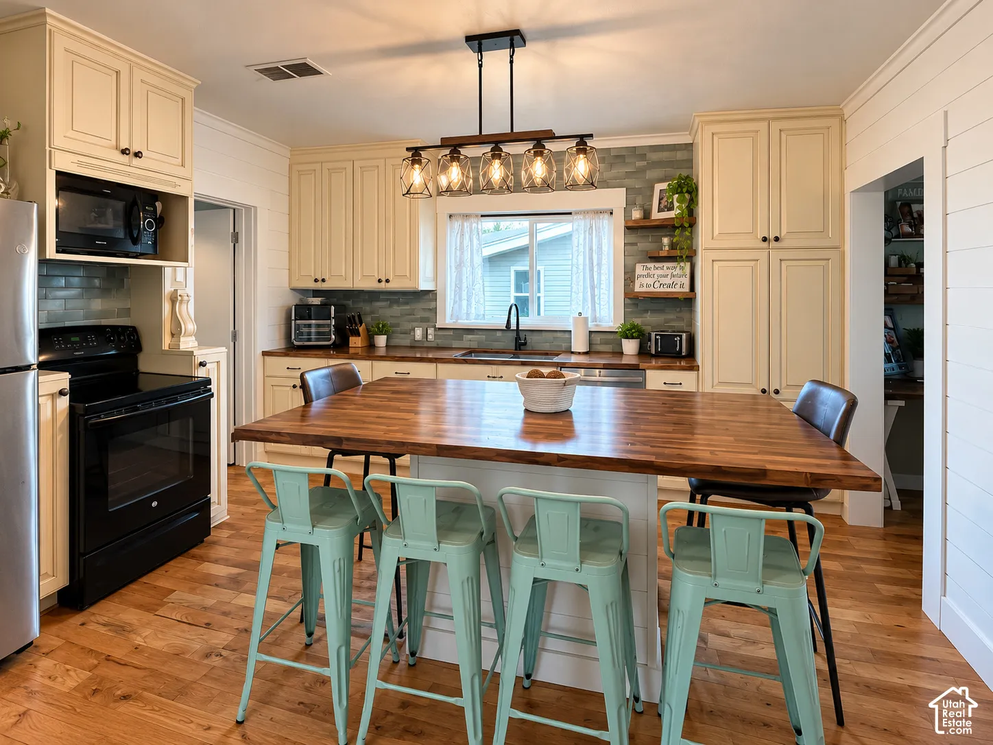 Kitchen featuring shaker-style cabinetry, butcher-block island countertop, subway tile backsplash, wood-finish flooring, and shiplap wall accents