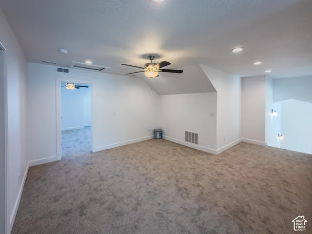 Neutral wall finishes, recessed lighting, carpeted flooring, and a ceiling fan with integrated light fixture