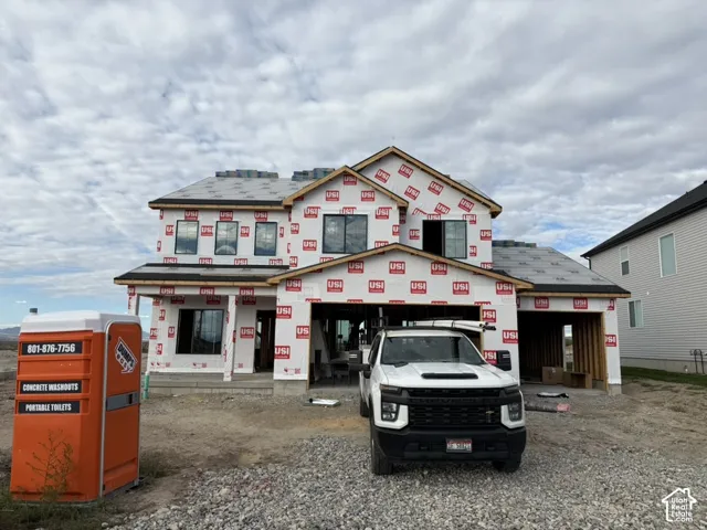 Two-story residential structure featuring a multi-gabled roofline and an integrated three-car garage