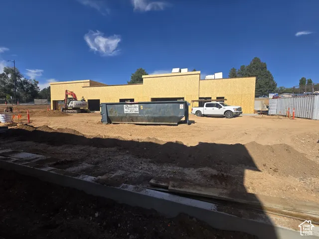 New construction project featuring a structural wood-frame building, exterior sheathing, and a level lot