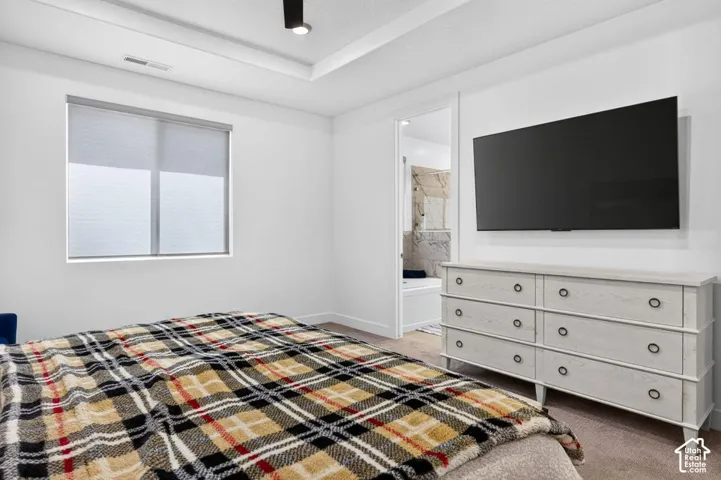 Tray ceiling featuring recessed lighting and neutral-toned wall-to-wall carpeting