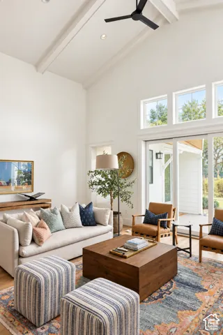 Vaulted ceiling with exposed beams, wood-finish flooring, recessed lighting, and expansive glass sliding doors