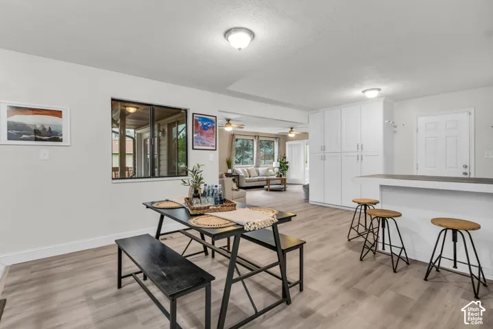Open-concept interior featuring wood-finish flooring, floor-to-ceiling built-in cabinetry, and a peninsula with a stone-finish countertop