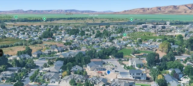 Aerial perspective of a residential neighborhood featuring mountain silhouettes and proximity to local lake shorelines