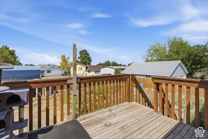 Raised wood deck featuring vertical balusters and a staircase