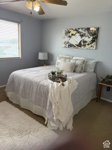 Neutral wall tones, ceiling fan with integrated lighting, and window blinds