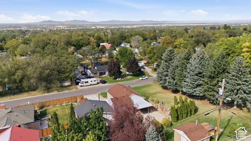 Expansive residential neighborhood featuring mature trees and distant mountain ranges