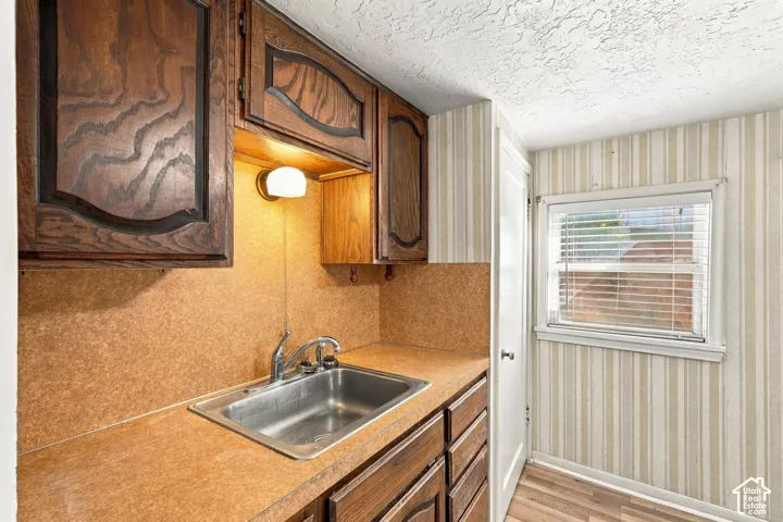 Laminate countertop with an integrated stainless steel sink and a chrome faucet