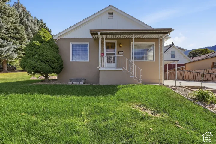 Warm stucco exterior with white trim details