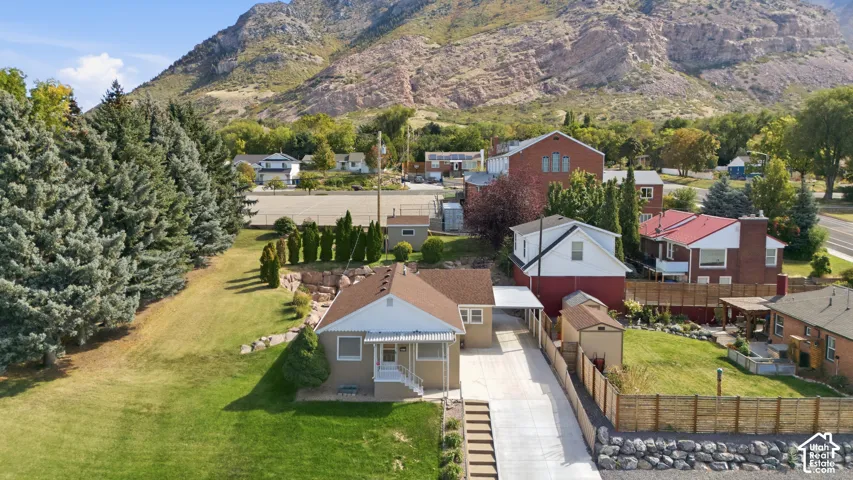 Single-level residence with a covered front porch, an extended driveway, and a detached carport
