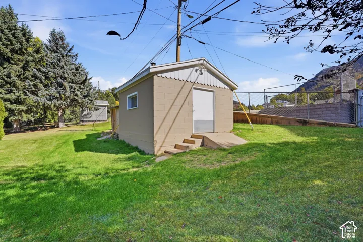 Detached accessory structure with a concrete pad and steps