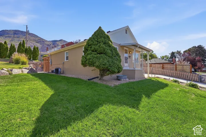 Property exterior with a covered porch, stucco siding, and a gabled roofline