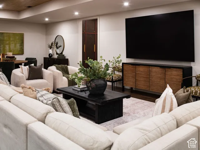 Recessed ceiling lighting, wood-finish ceiling, dark wood-finish flooring, and a built-in wall cabinet with dark wood finish