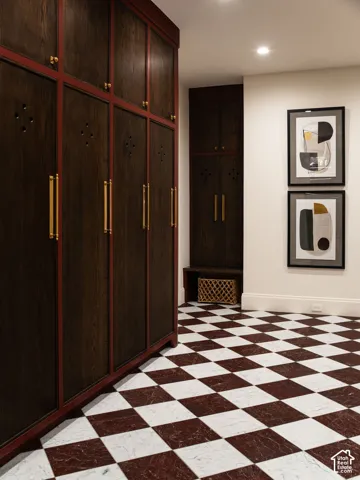 Dark wood-finish cabinetry with red trim and brass hardware