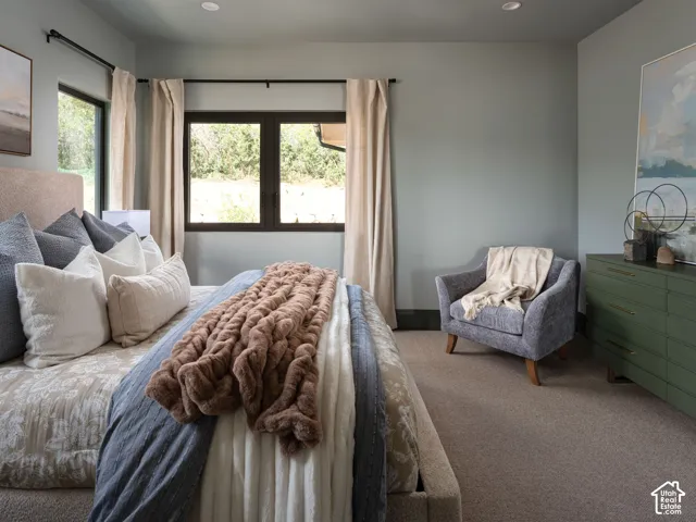 Room featuring wall-to-wall carpeting, recessed lighting, and a window with drapes