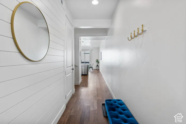 Entryway featuring horizontal shiplap wall paneling, wood-finish flooring, recessed lighting, and a wall-mounted metal coat hook rack