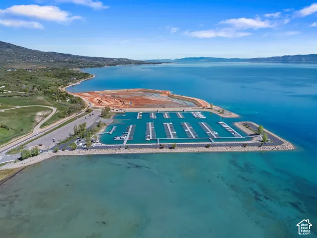 Aerial perspective of a multi-slip marina featuring stone-reinforced embankments, paved parking areas, and expansive water access
