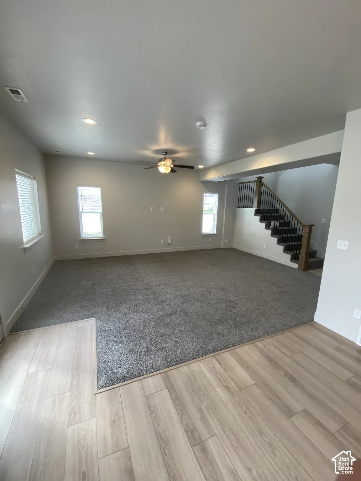 Interior space featuring wood-finish flooring, recessed lighting, ceiling fan, and carpeted flooring