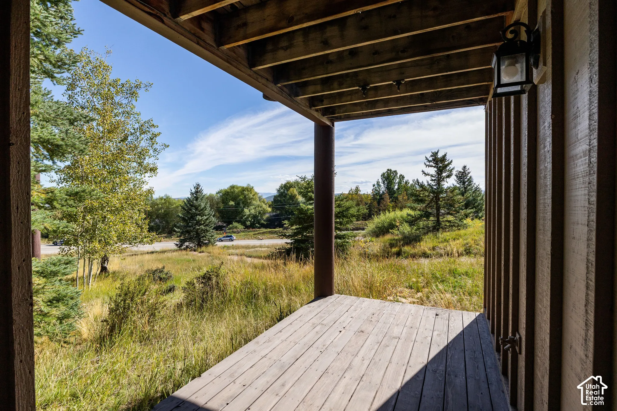 Outdoor decking with wood paneling and exposed ceiling joists