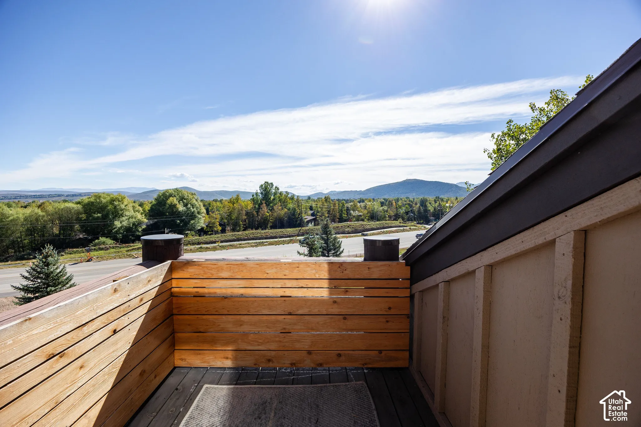 Private deck with natural wood paneling and distant mountain scenery