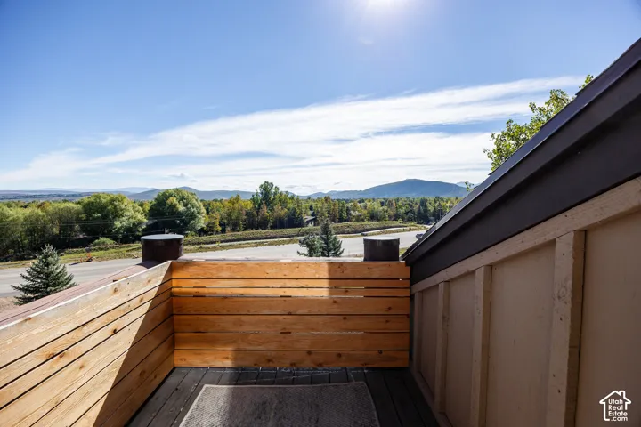 Private deck with natural wood paneling and distant mountain scenery