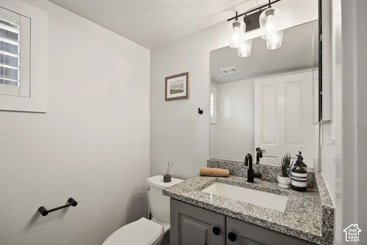 Granite-finish countertop with an integrated sink, dark cabinet vanity, and a matte black faucet