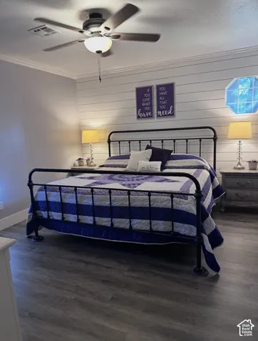 Horizontal shiplap accent wall, wood-finish flooring, and an octagonal window with a multi-light grid pattern, featuring a ceiling-mounted light fixture with integrated fan
