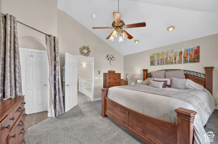 Vaulted ceilings, neutral wall tones, recessed lighting, and a ceiling fan with multi-light fixture