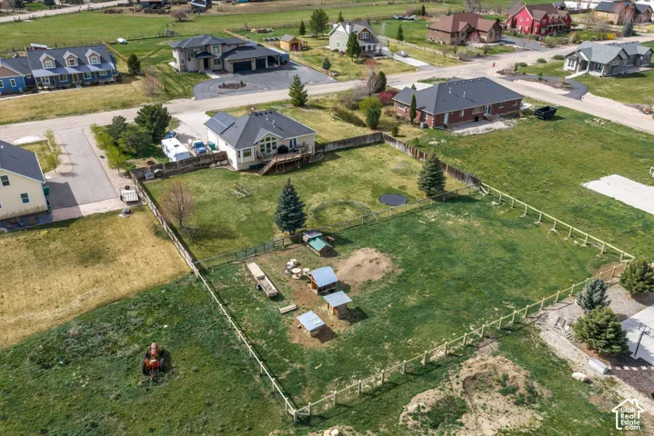 Expansive lot featuring a fully fenced perimeter, elevated wooden deck, and mature evergreen trees