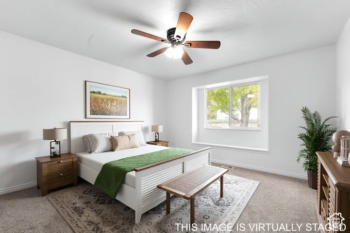 Neutral interior with a window seat, carpeted flooring, and a ceiling fan with integrated lighting