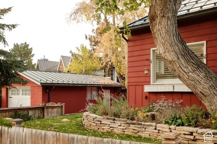 Red siding exterior with a white trim window and exterior lighting fixture