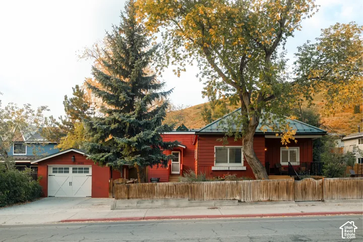 Red siding exterior with a dark metal roof
