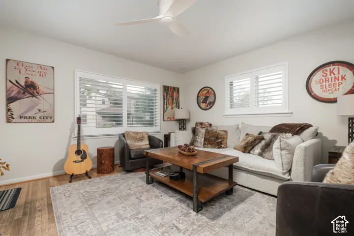 Recessed lighting, wood-finish flooring, and a ceiling fan with integrated lighting
