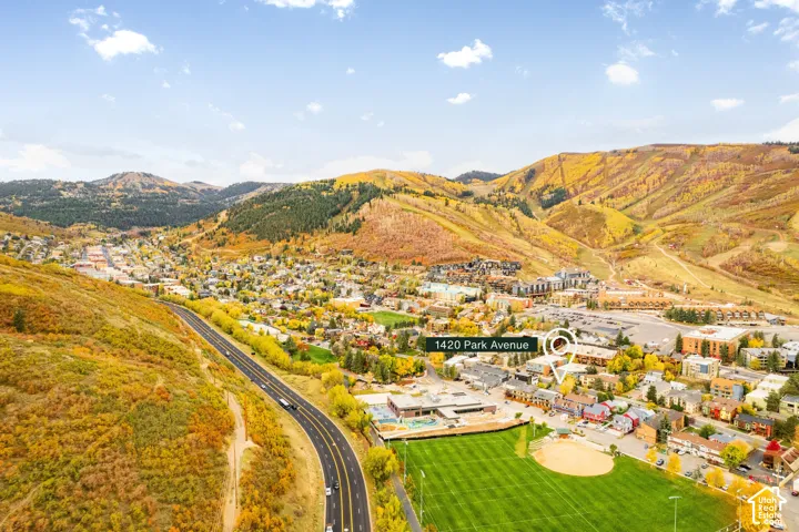 Aerial perspective featuring mountain landscape, proximity to recreational sports fields, and urban center access